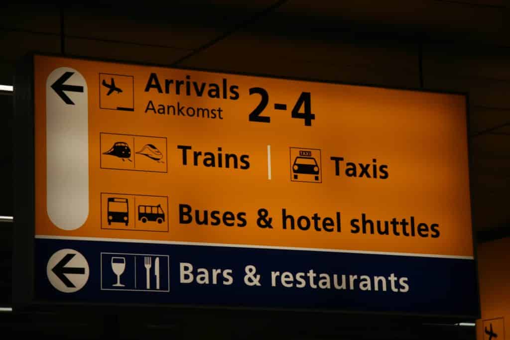 Sign with directions to public transport at Schiphol Airport in Amsterdam